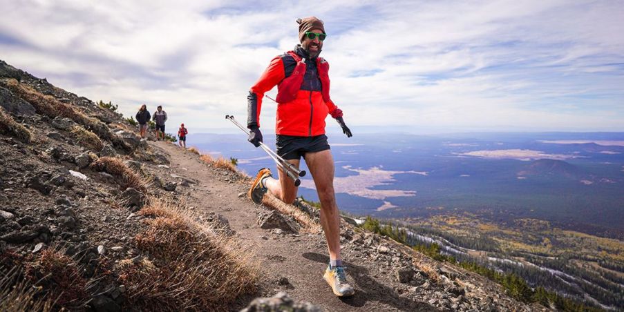 Peter Mortimer running on a single track trail on a mountain.