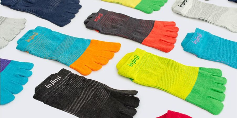 A flat display of the bright and fresh colorways of the redesigned Injinji Run series toesocks.