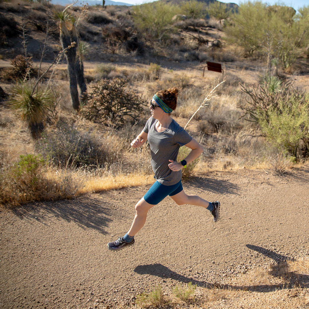 Female running on a trail in the desert. 