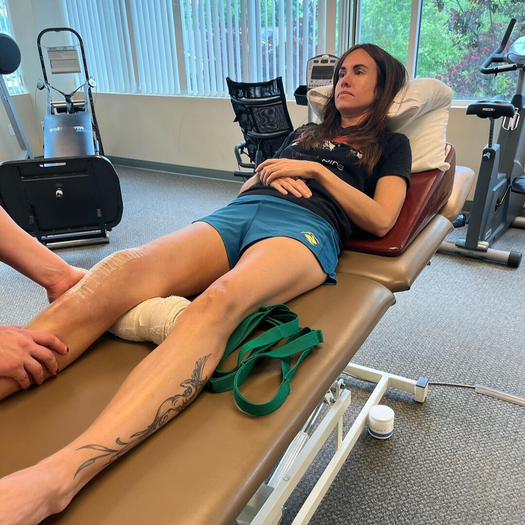 Trish Arends laying on a reclining seat at a physical therapist's office.