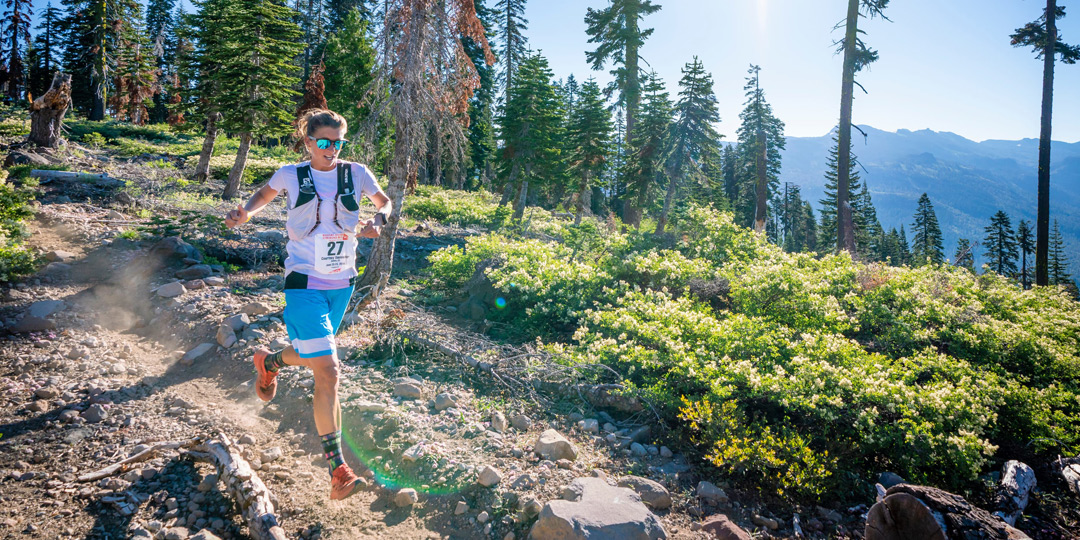 Team Injinji athlete Courtney Dauwalter running downhill at Western States 100 ultramarathon.