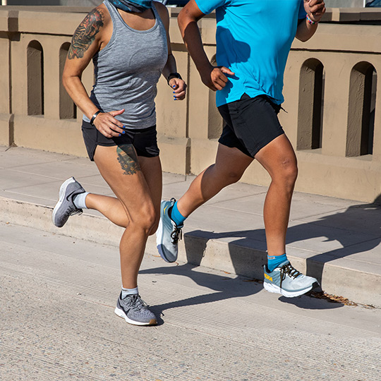 A man and woman road running in Injinji mini-crew toesocks. 