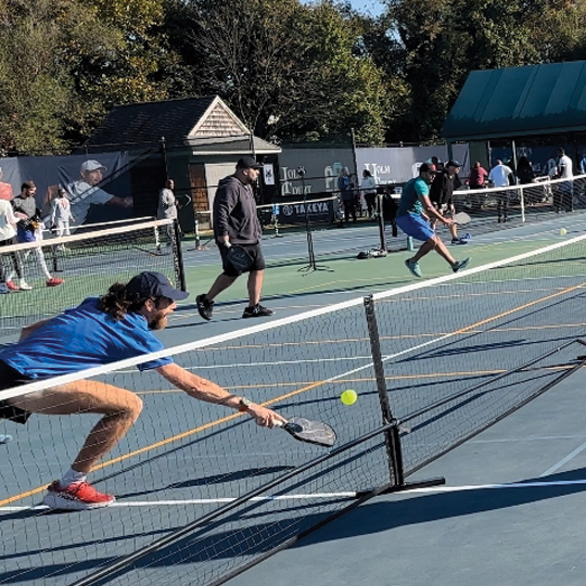 Mike Wardian diving for the ball during a game of pickleball. 