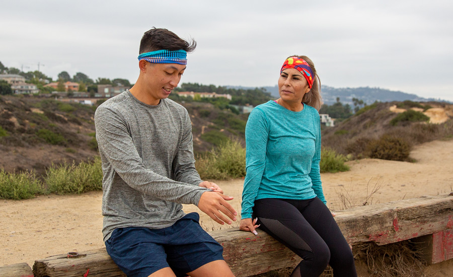 Man and Woman wearing Injinji x Buff in Alto and Brush 