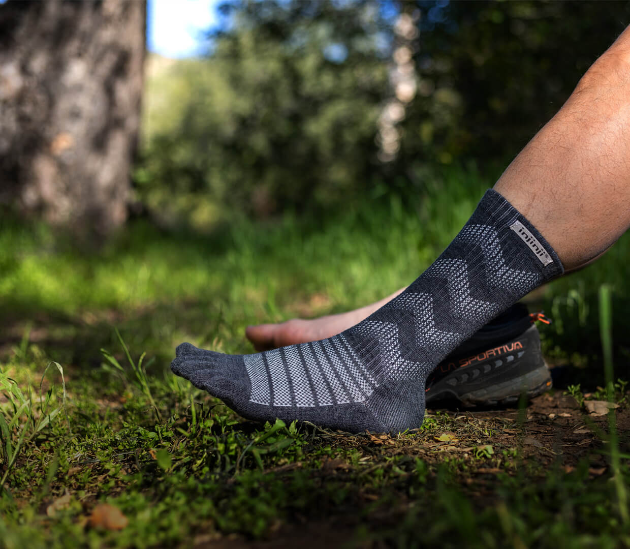 A hiker's foot wearing Injinji Outdoor Midweight Crew Wool