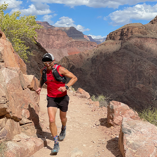 Male athlete running at the Grand Canyon North Rim. 