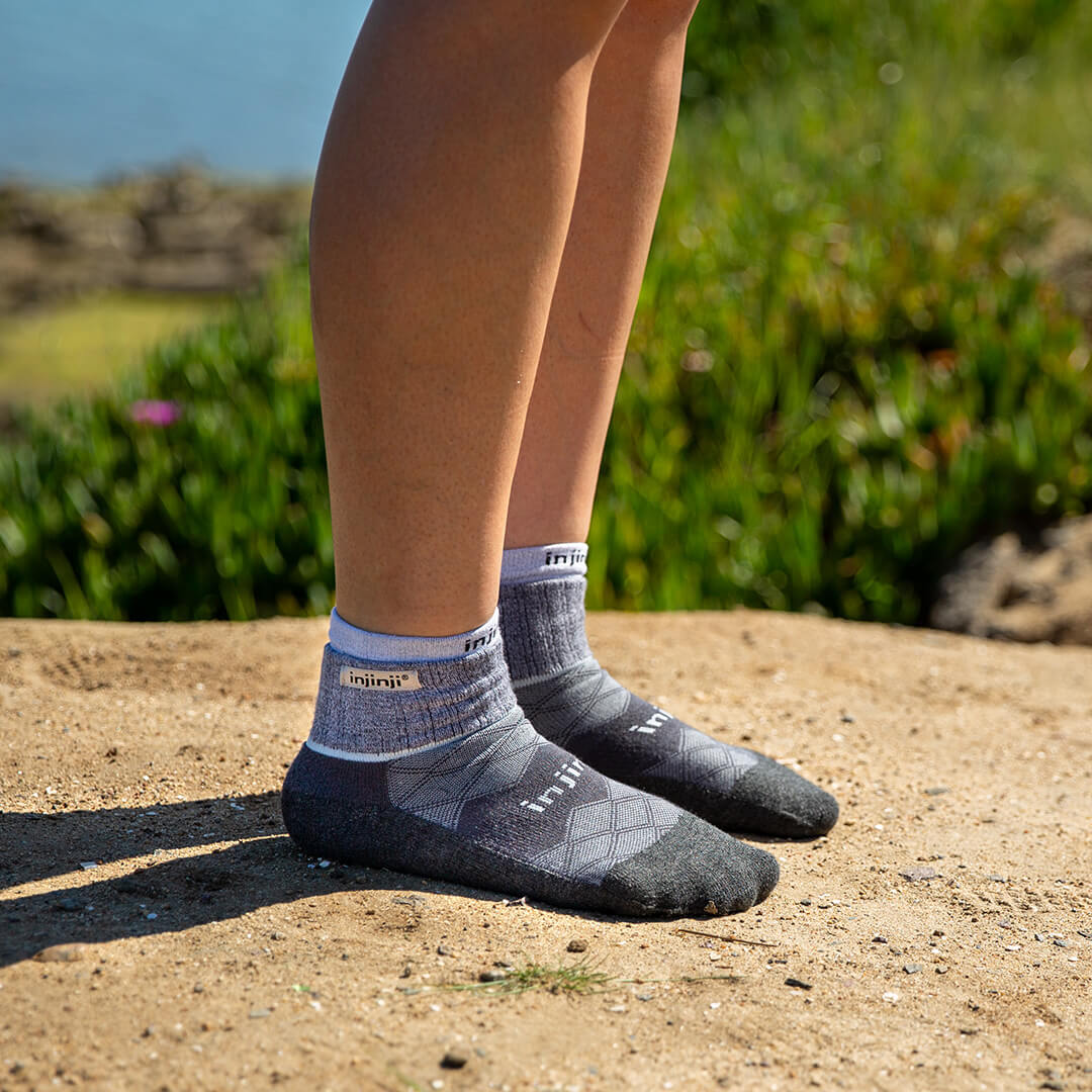 A woman putting on a pair of running socks