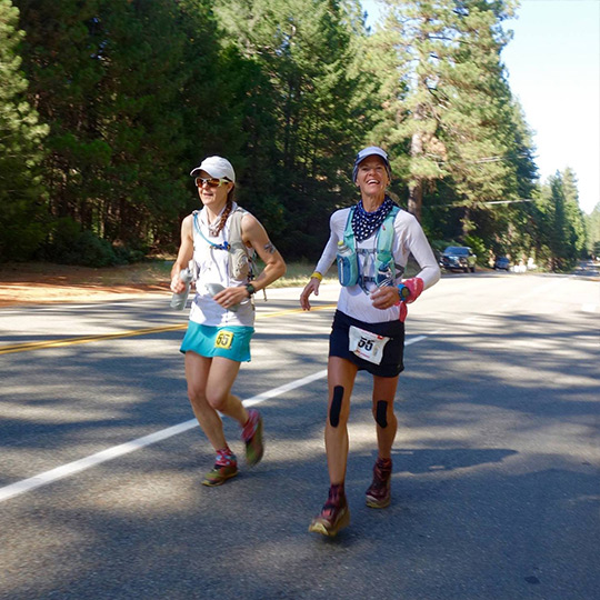 Two female athletes running at the Western States 100 Mile Endurance Run. 